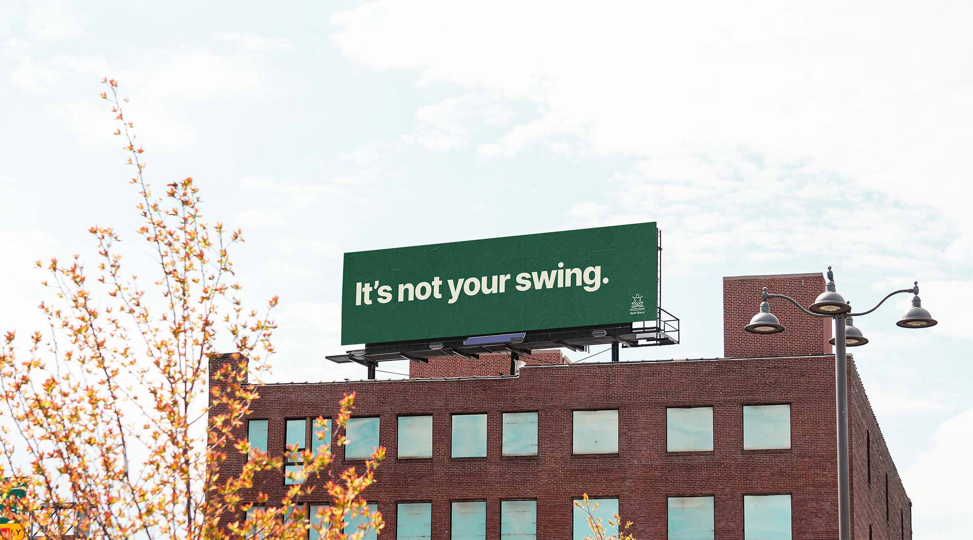 Rooftop billboard in Guru Green reading “It’s not your swing.”